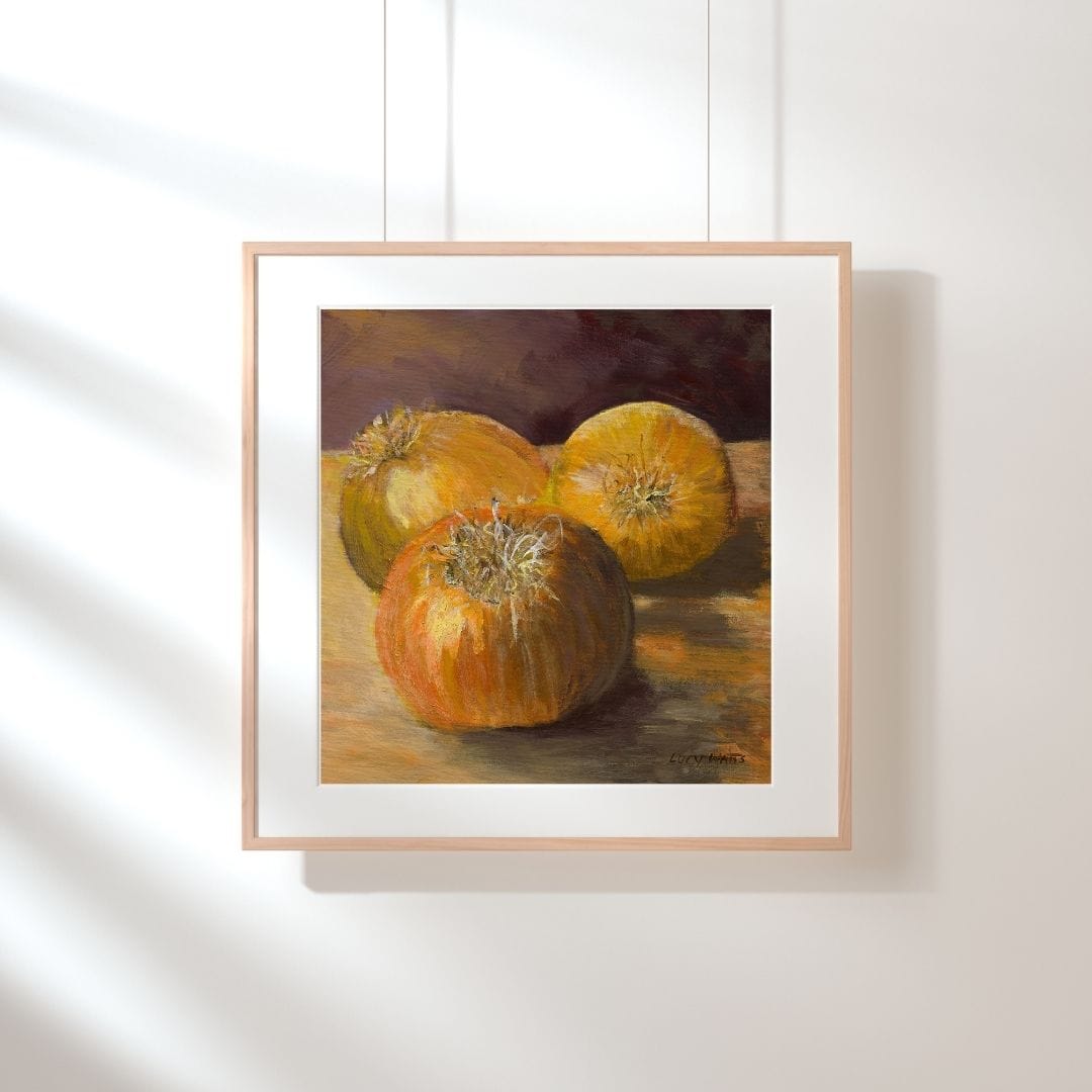 Framed painting of three pumpkins on a white wall