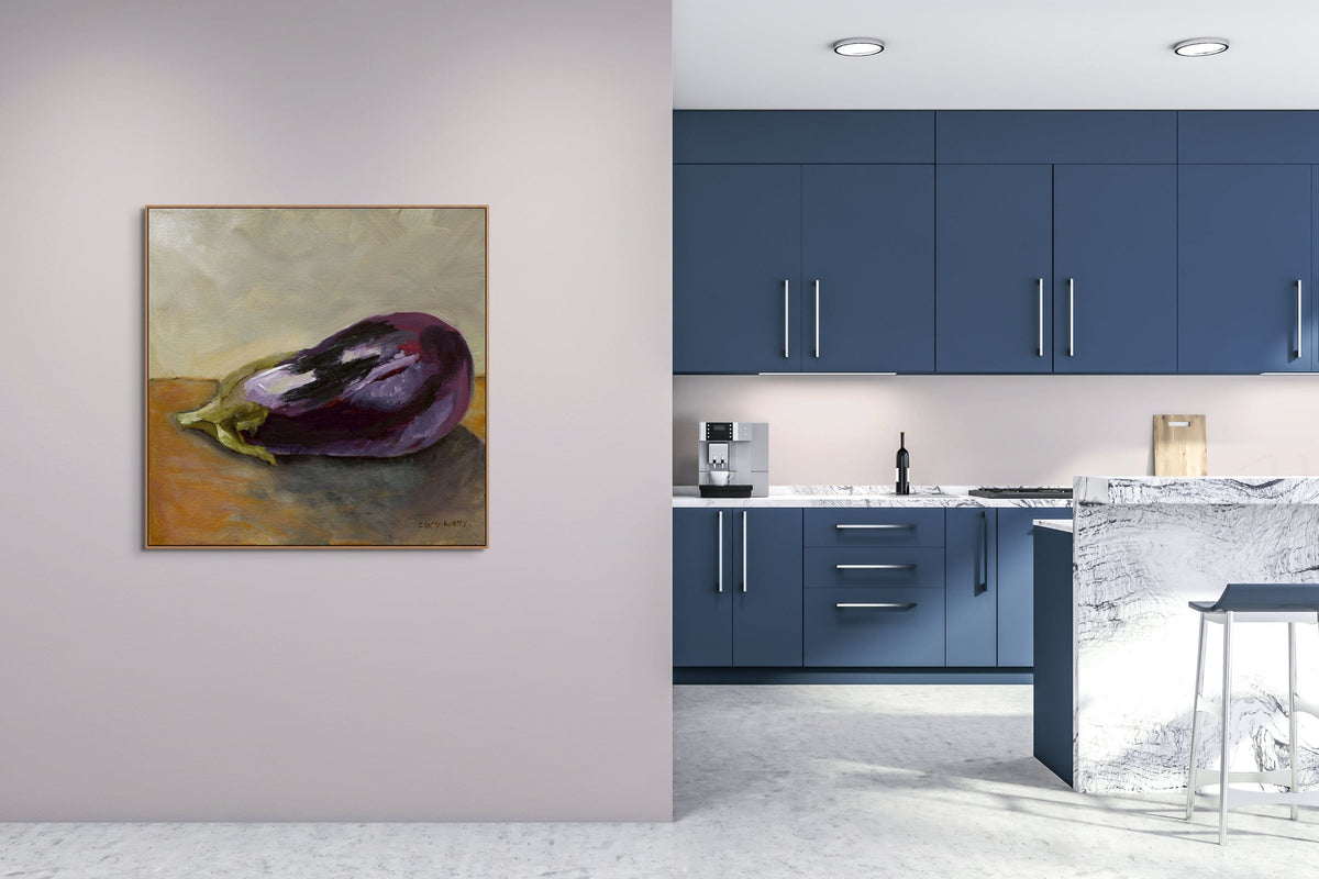 Modern kitchen with blue cabinets and a painting of an eggplant on the wall.