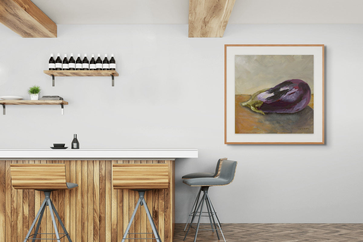 Modern kitchen with wooden bar stools, a countertop, and a framed painting of an eggplant on the wall.